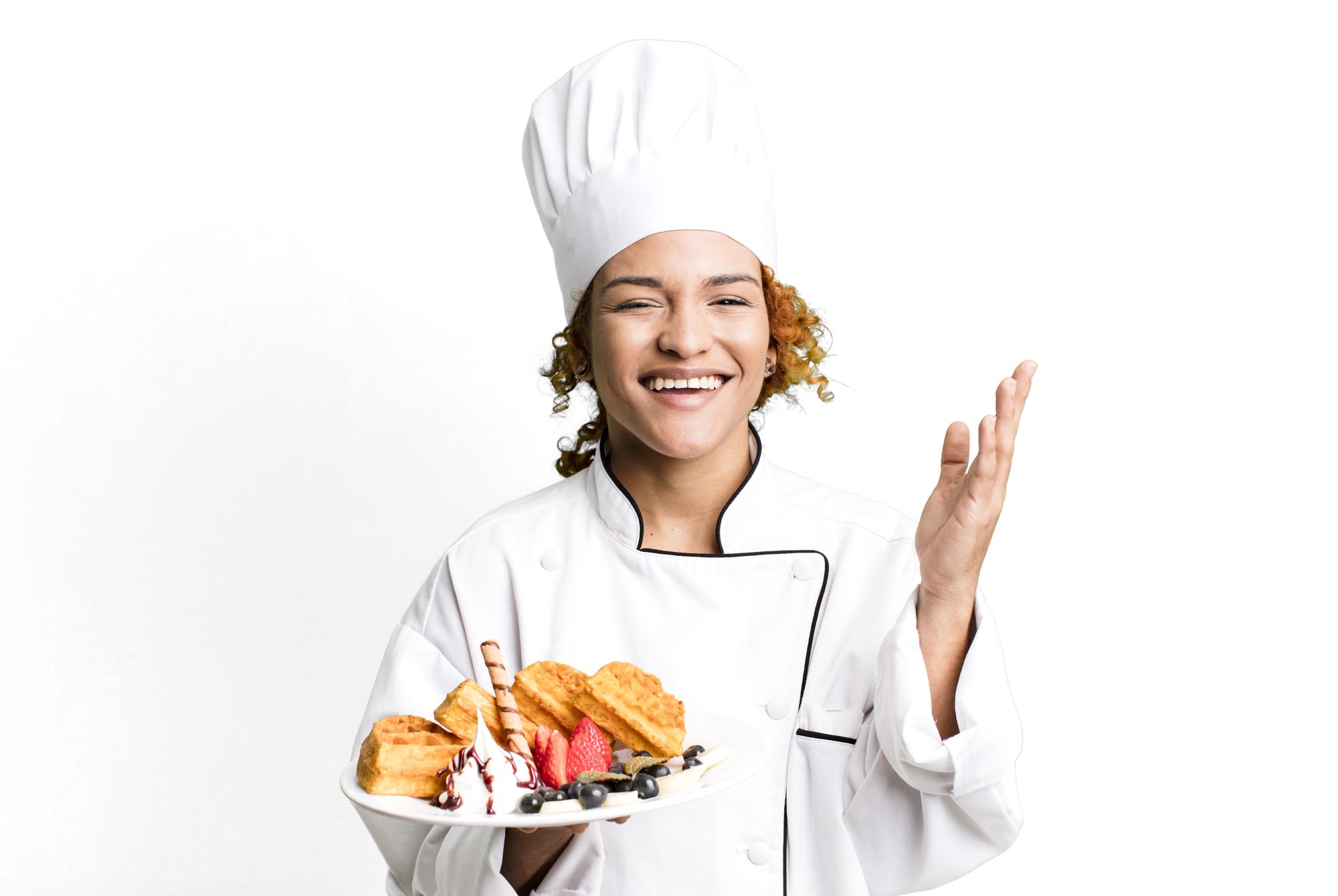 Chef smiling with a tray of prepared appetizers