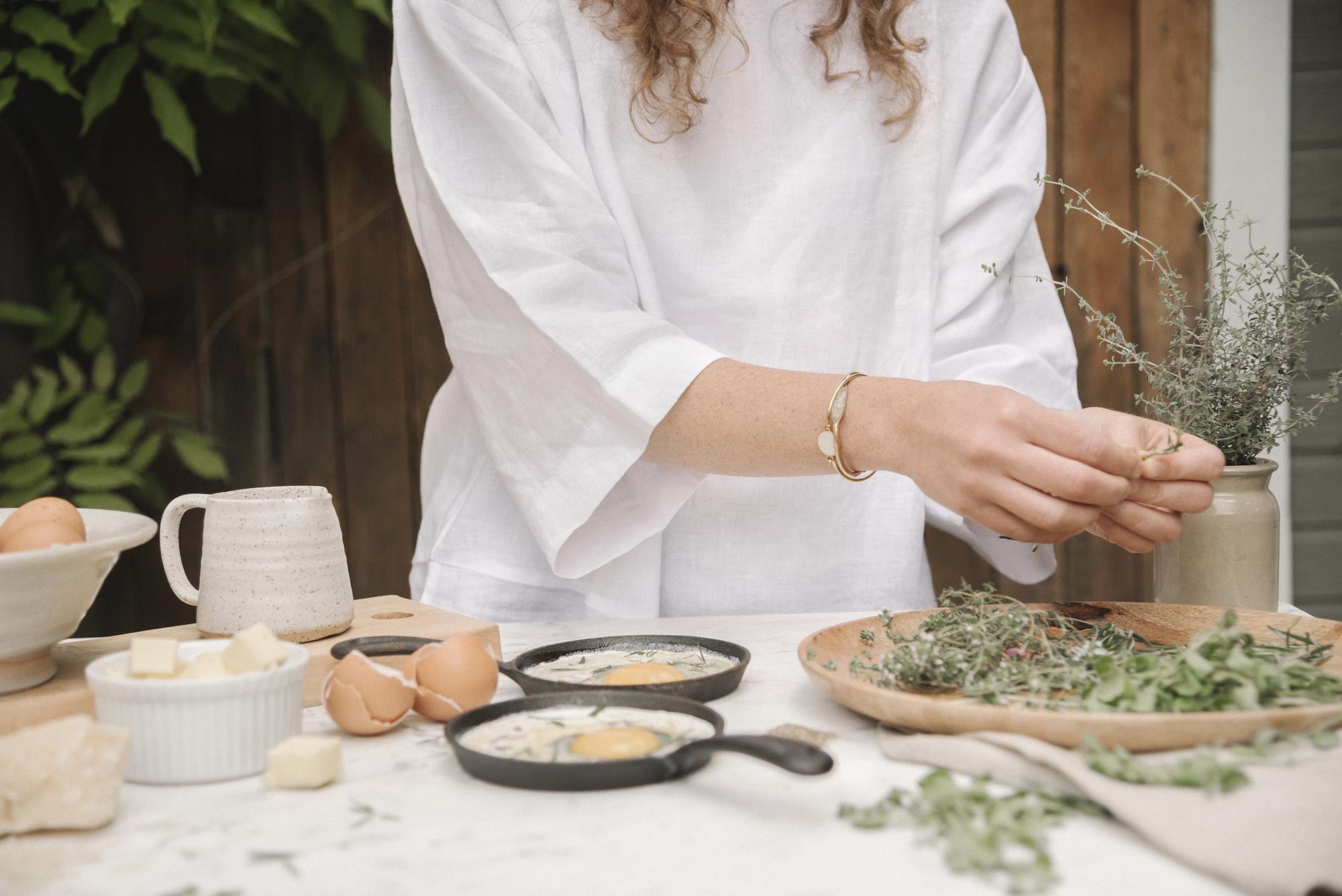 Warm studio counter with utensils and herbs